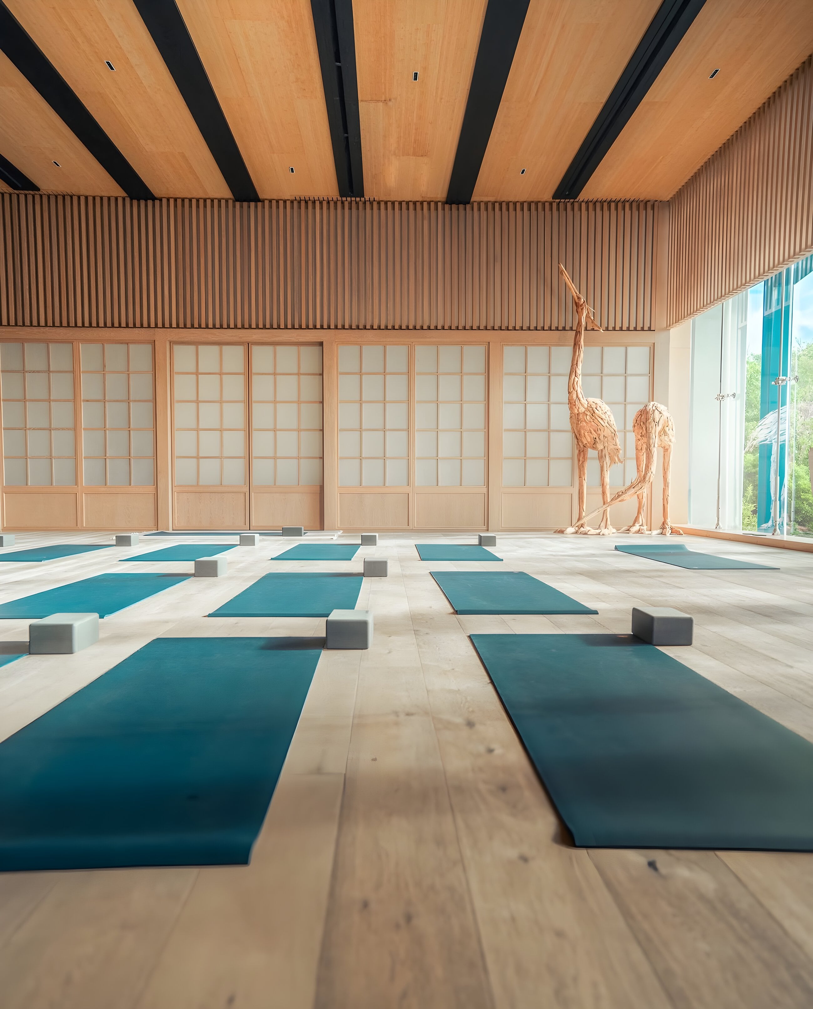 The movement studio at Palmaïa, with mats laid out on a wooden floor